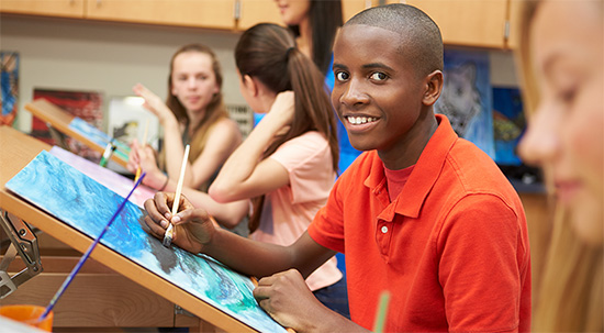 Teens painting on canvas